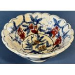 Chinese lobed bowl in under-glazed blue and red with grape and leaf decoration and seven character