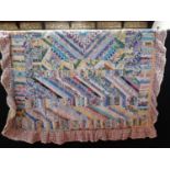 Cottage style patchwork quilt with numerous log shaped fabric patches, machine stitched with gingham