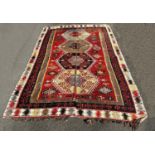 A large old Kilim with a central row of large diamond medallions in bright repeating colours , faded