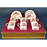 A boxed set of six Royal Crown Derby floral pattered coffee cans and saucers, a Royal Crown Derby
