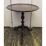 A Georgian style mahogany occasional table, the circular dished top set within a shaped outline,