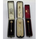 Four antique gold stick pins; 14k maple leaf example set with seed pearls (centre pearl vacant)