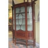 A good quality Edwardian mahogany display cabinet of full height, the central door with applied