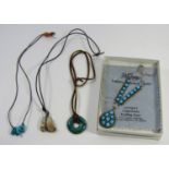 Four Native American pendant necklaces comprising a silver example set with turquoise and three cord