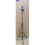 Telescopic iron oil lamp standard with scrolled detail, brass fittings and reservoir (later