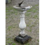 A weathered contemporary sun dial, the loose engraved circular plate with shaped gnomon raised on
