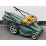 An Atco electric lawn mower with grass collection box