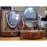 Two Georgian mahogany toilet mirrors one with shield shaped mirror plate on bow fronted base, the