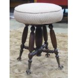 Late 19th century piano stool with revolving seat, fluted supports, with iron and glass castors