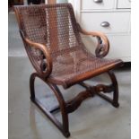 Unusual regency style X framed cane panel armchair