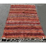 Two contemporary wool Rag Rugs, one in a rusty colour way, the other in pale pinks and cream,