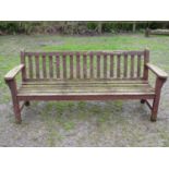 A large vintage heavy gauge stained and weathered teak garden bench with slatted seat and back,