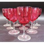 Ten near matching cranberry wine glasses, two green similar, and seven small aperitif glasses.