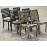 A set of six stained and weathered Gloster teak garden chairs with slatted seats and backs (