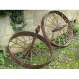 A pair of antique cast iron sixteen spoke agricultural related implement wheels 90 cm in diameter