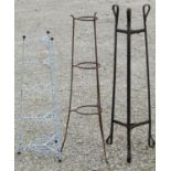 Three iron work stands of varying design and purpose, the tallest example one metre high