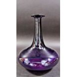 An elegant amethyst coloured flat bottomed glass carafe, a small amethyst coloured glass jar, and