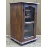 Low hardwood side cabinet enclosed by a moulded glazed panelled door, with wine rack to interior, to