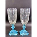 A collection of Victorian glass lustres in various states of completion, two tall vases with blue