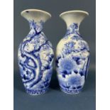 A pair of Japanese oviform vases with trumpet shaped necks and hand painted landscape detail