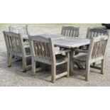 A Woodfurn heavy gauge weathered teak garden table with rectangular overhanging slatted panelled top