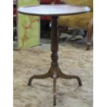 A Georgian mahogany occasional table with circular dished top, raised on a gun barrel shaped