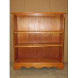 A reproduction yew wood veneered freestanding open bookcase with two adjustable shelves, 95cm wide x