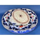 A large blue and white meat plate with landscape detail, a further 19th century meat plate with