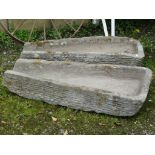 A pair of weathered carved natural stone tapered shutes 55 cm (at widest point) tapering to 23 cm