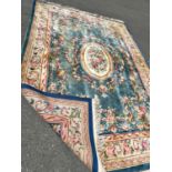 A large 18th century style thick pile wool carpet in the Neoclassical style of a floral pattern on a