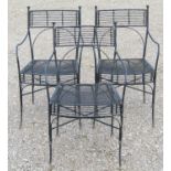 A set of three heavy gauge iron work garden open armchairs with x framed stretchers