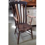 A Victorian Windsor lathe back elbow chair principally in elm and beech on turned supports