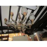 Cast gilt metal eight branch chandelier with scrolling acanthus and female mask detail, bulb