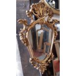 A decorative gilt frame shield shaped wall mirror with acanthus, scrolled and other detail, 80cm max