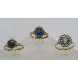 Three gem set cluster rings; a 9ct sapphire and diamond example, 9ct spinel example and a yellow