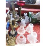 Two brass column oil lamps, a squat brass oil lamp, two electric brass column table lamps, five