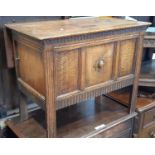 A small Edwardian panelled oak combination coffer on six supports, the drop leaf to the rear with