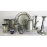 A collection of 18th and 19th century pewter ware, including a pair of candle sticks, tankards,