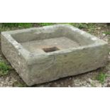 A shallow weathered natural stone trough with square central drainage hole 53 x 50 cm x 16 cm high
