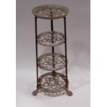 A vintage four tier saucepan rack with lions paw feet