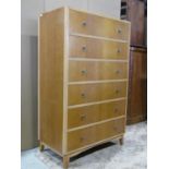 A mid 20th century oak veneered upright tower of six drawers on swept supports 85 cm wide