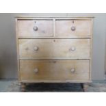 A stripped and waxed pine chest of two long and two short drawers on turned supports, 92 cm wide