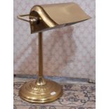 A bankers lamp in brass