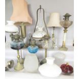 A brass Corinthian column, table lamp, a brass adjustable students lamp, four oil lamp bases a