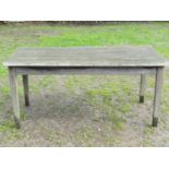 A weathered teak garden table with rectangular slatted panelled top raised on square tapered