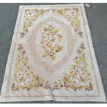 An 18th century style tapestry wall hanging with a lime green floral design on fawn ground, and