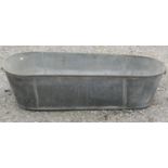 A vintage galvanised tin bath of tapered form 135 cm long x 53 cm at widest point