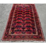 A Geometric multi coloured Middle Eastern carpet, 237cm x 144cm approx.