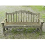 A Swan Hattersley weathered teak three seat garden bench with slatted seat and back beneath an