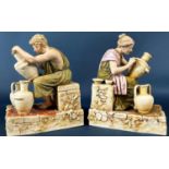 A pair of Royal Dux figures of male and female characters decorating ceramic pots